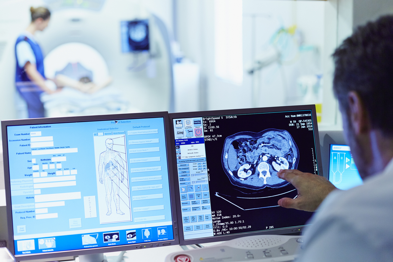 Doctor running CT scan from control room